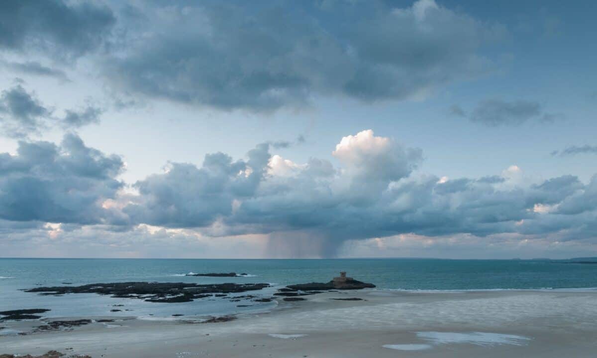 Beach, sea, clouds and La Rocco Tower from La Carrière headland