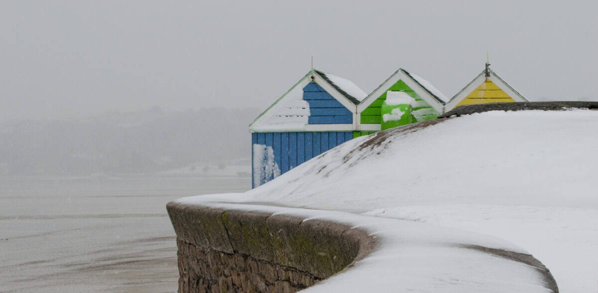 Blue, green and yellow hut in the snow at Bel Royal