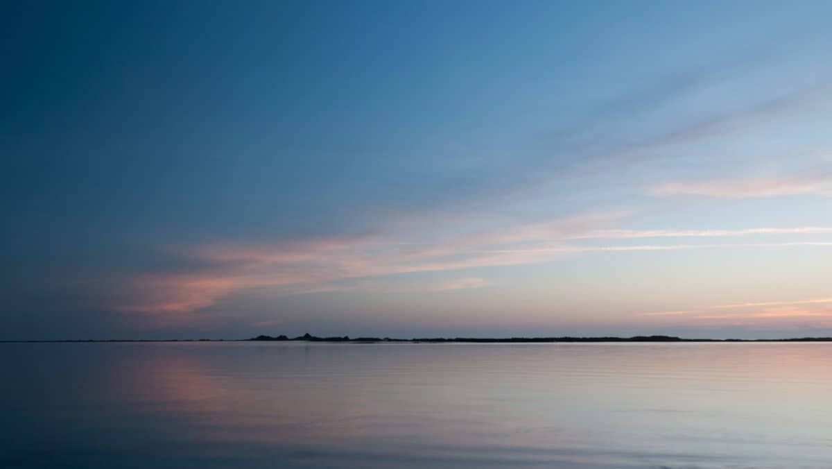Calm sea and rocks at sunset, La Pulente, St.  Brelade, Jersey