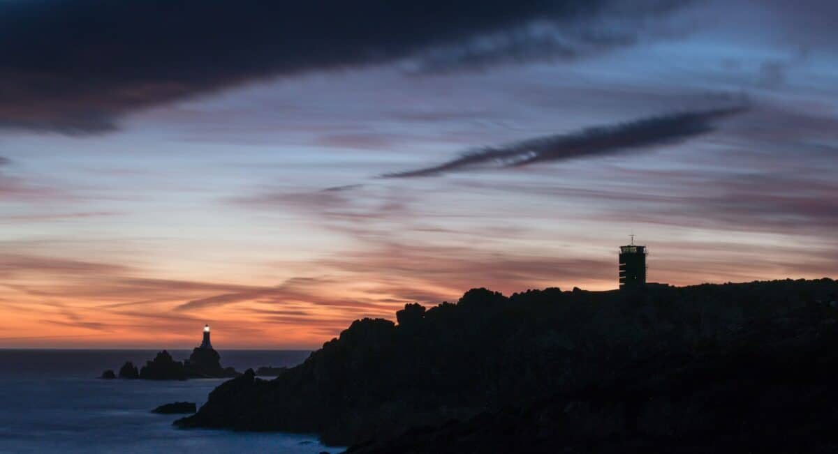 Corbière Lighthouse and silhouetted cliffs and the Radio Tower