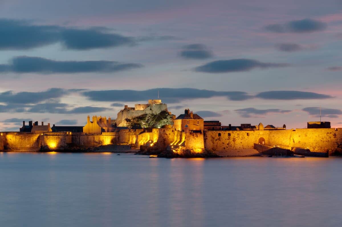 Illuminated Elizabeth Castle at sunset, St. Helier Marina
