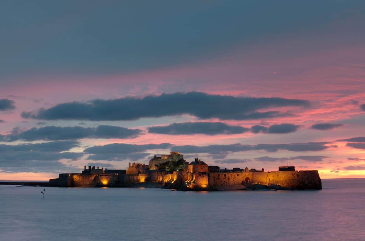 Illuminated Elizabeth Castle at sunset, St. Helier Marina