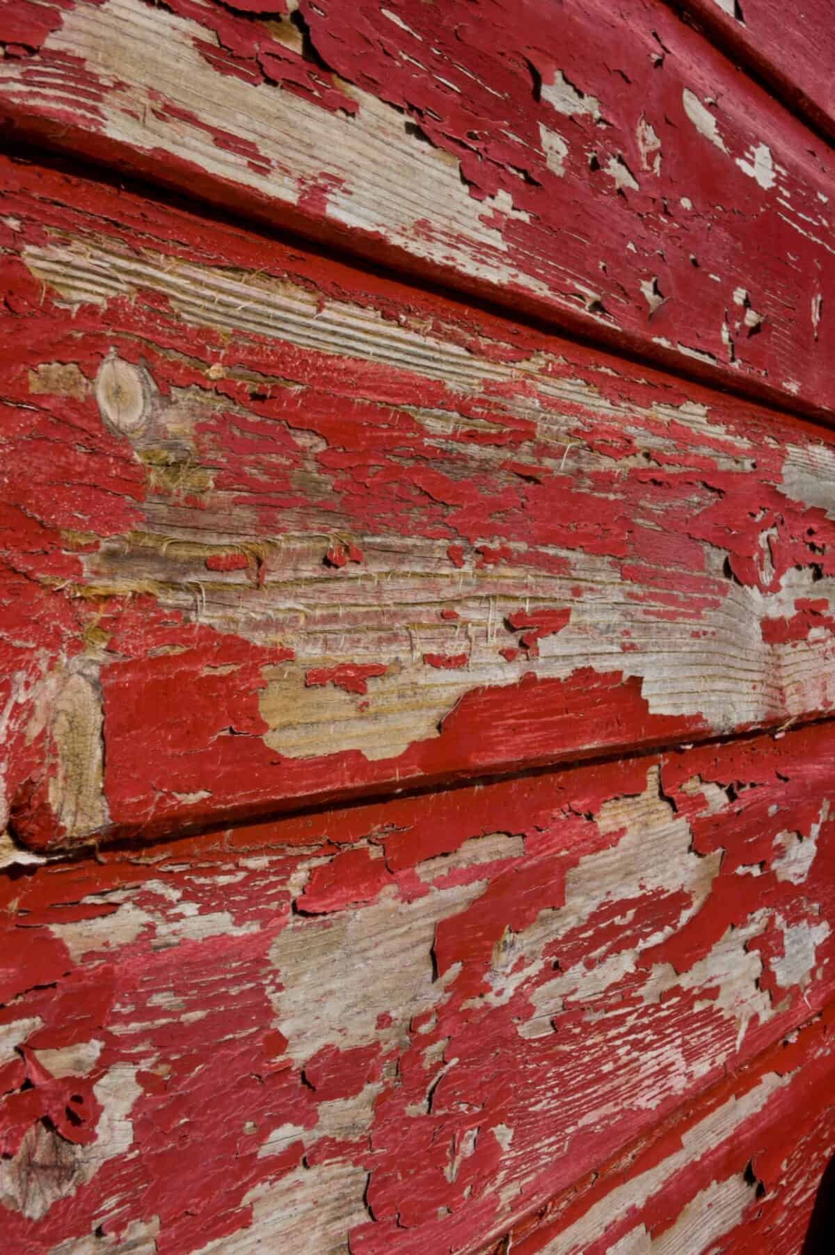 Flaking paint on old red fishing hut on Rozel Pier, Rozel Bay