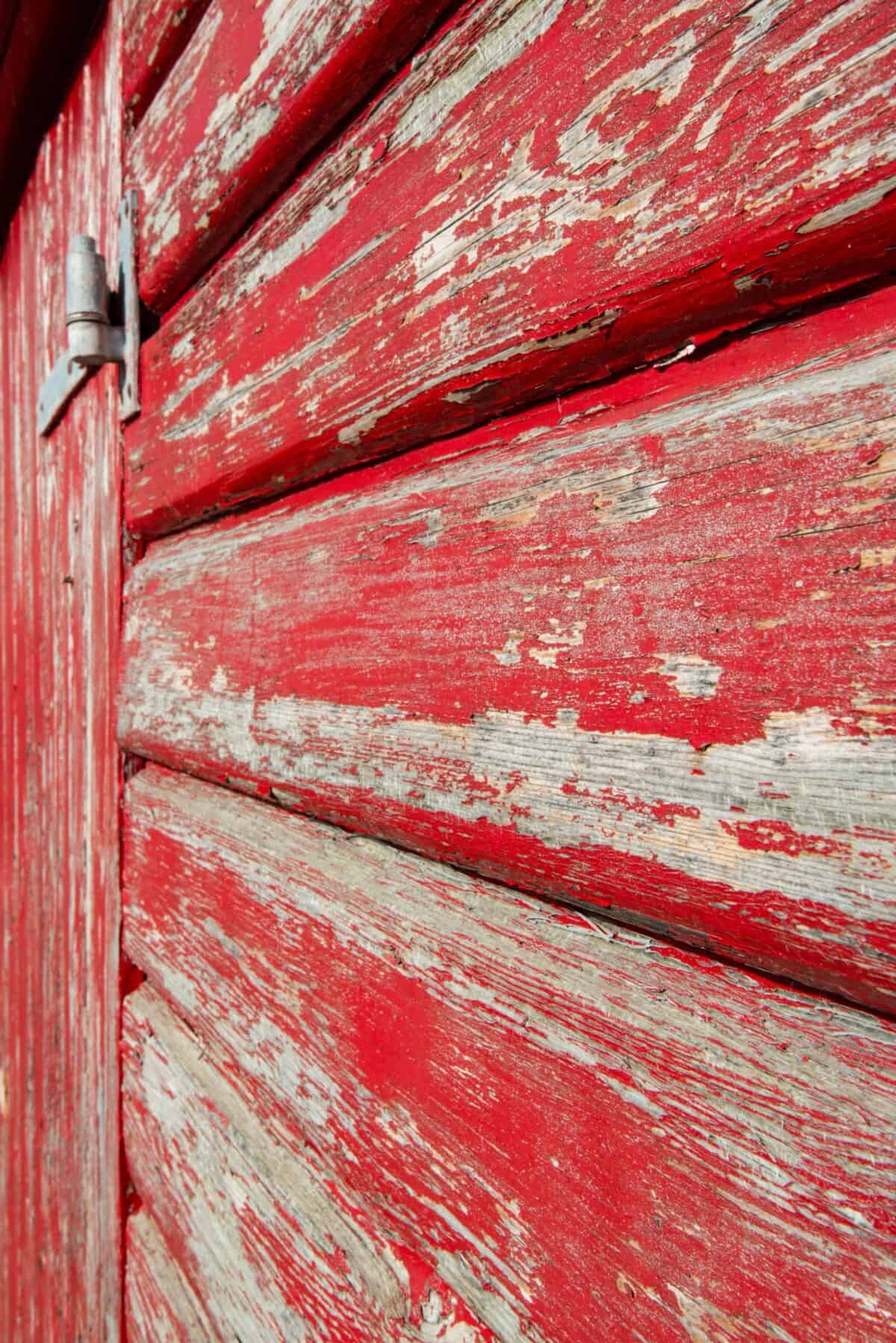 Flaking paint on old red fishing hut on Rozel Pier, Rozel Bay
