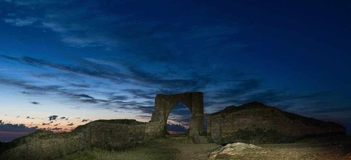 Grosnez Castle ruins after sunset by torch, St. Ouen, Jersey