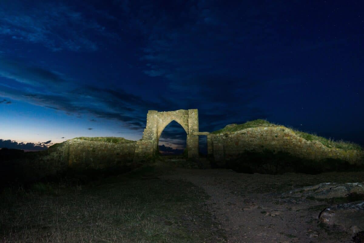 Grosnez Castle ruins after sunset by torch, St. Ouen, Jersey