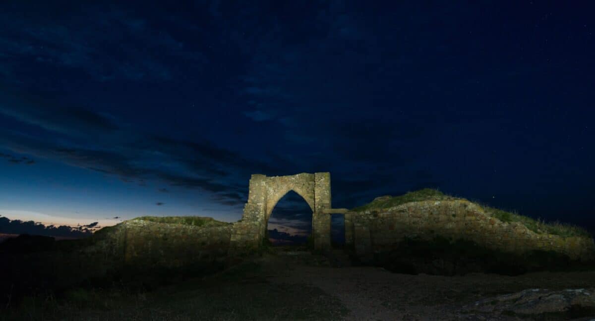 Grosnez Castle ruins after sunset by torch, St. Ouen, Jersey