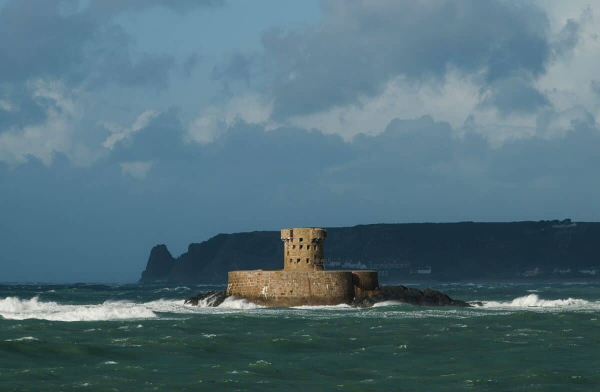 Wild and windy seascape after heavy rain showing La Rocco Tower