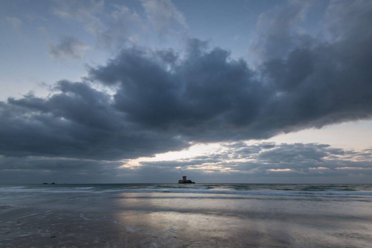 La Rocco Tower at sunset with big fluffy clouds, El Tico