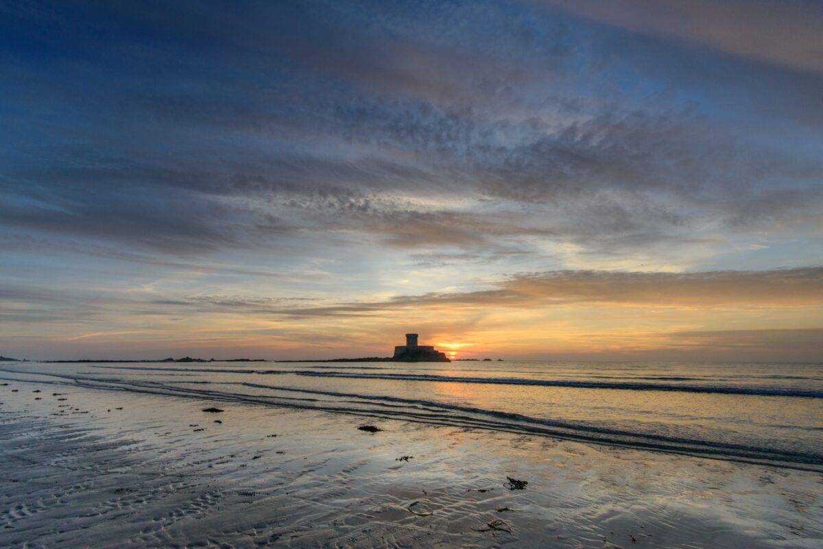 La Rocco Tower sunset reflecting on the sand and waves, El Tico