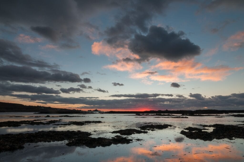 Low tide sunset at Le Braye looking to Corbière Lighthouse