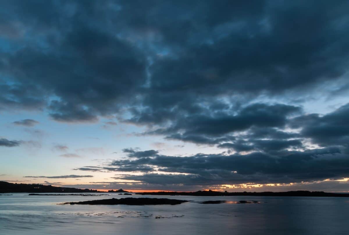 Low tide sunset at Le Braye looking to Corbière Lighthouse