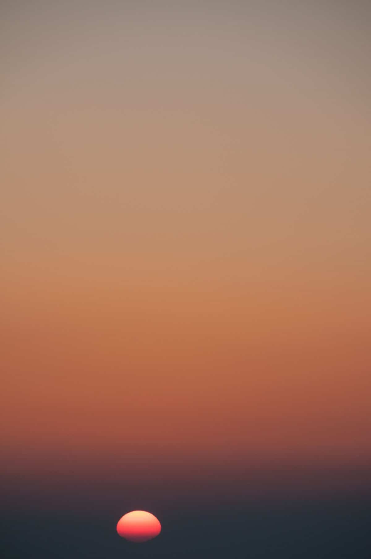 Orange gradient sunset over the sea near Corbière, St. Brelade