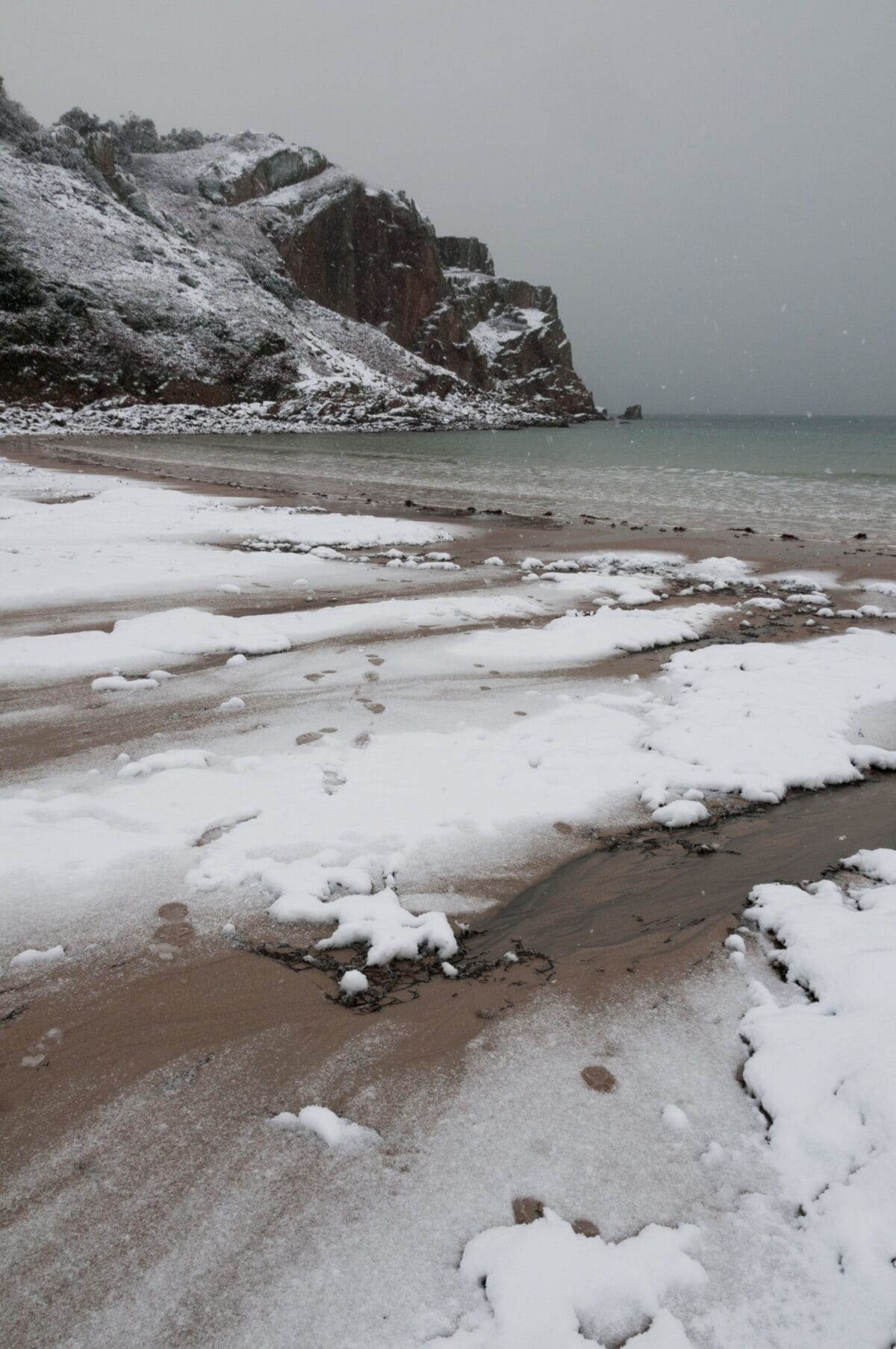 Ouaisné Bay in the snow, St. Brelade, Jersey, Channel Islands