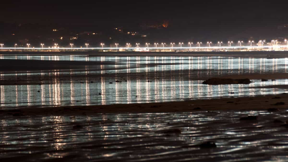 Lighting reflected in the wet sand at St. Aubin's Bay, West Park