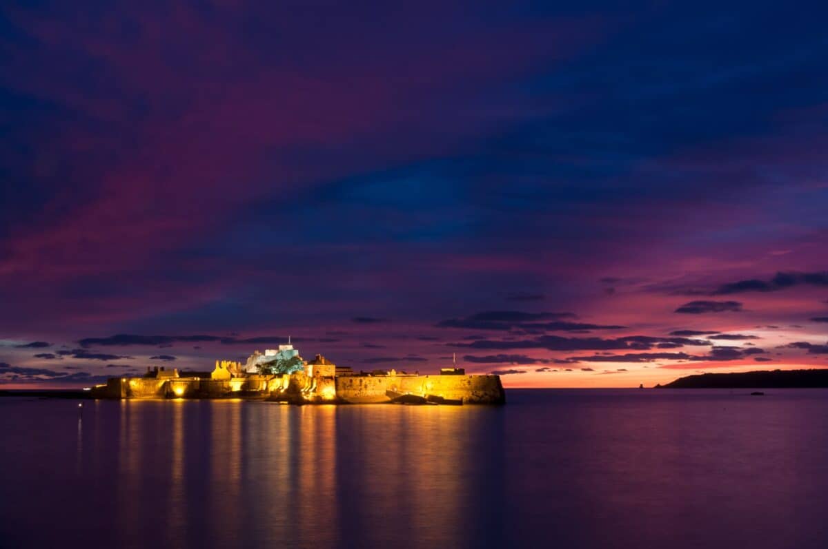 Purple sunset and lit Elizabeth Castle, St. Helier Marina