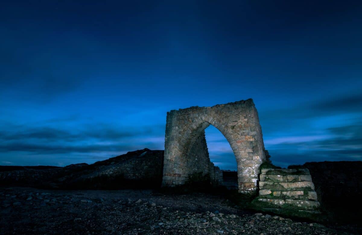 Rear of Grosnez Castle lit up at night with a torch, St. Ouen