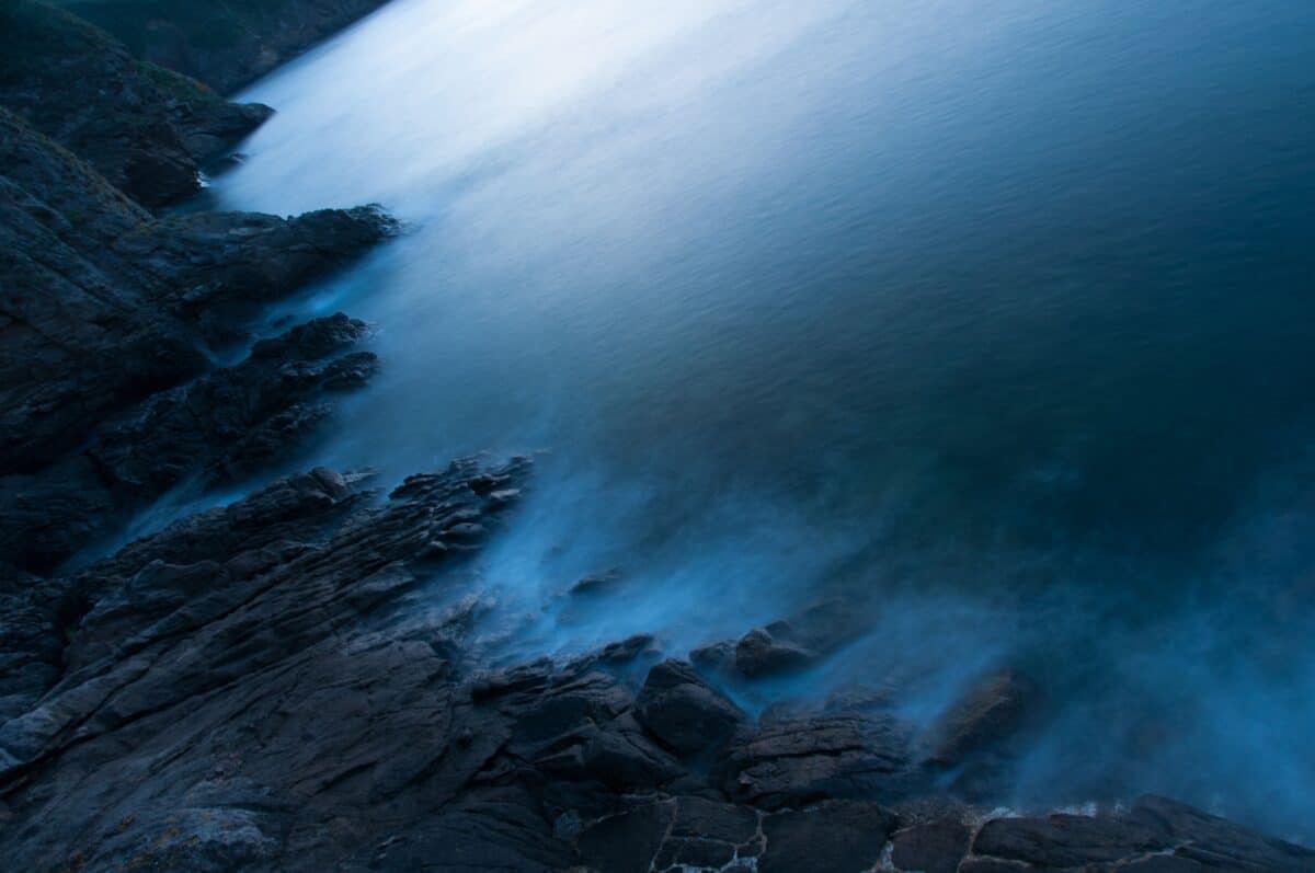 Sea and rocks after sunset from Grève De Lecq Pier