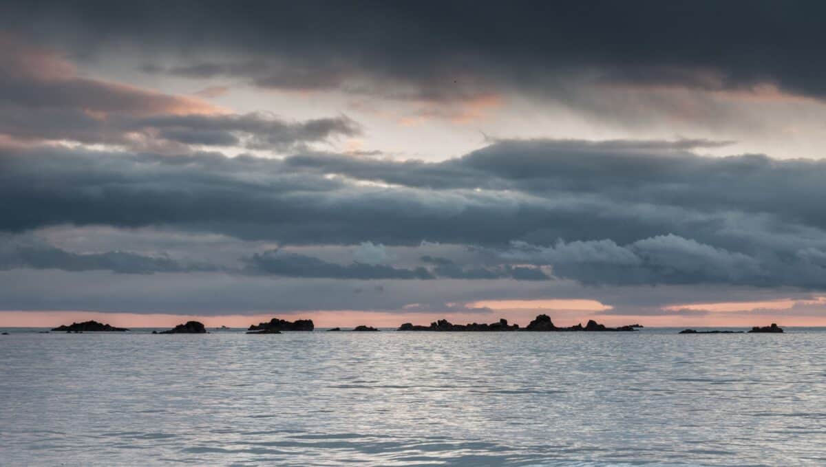 Sea and rocks at sunset from La Greve D'Azette, St. Clement