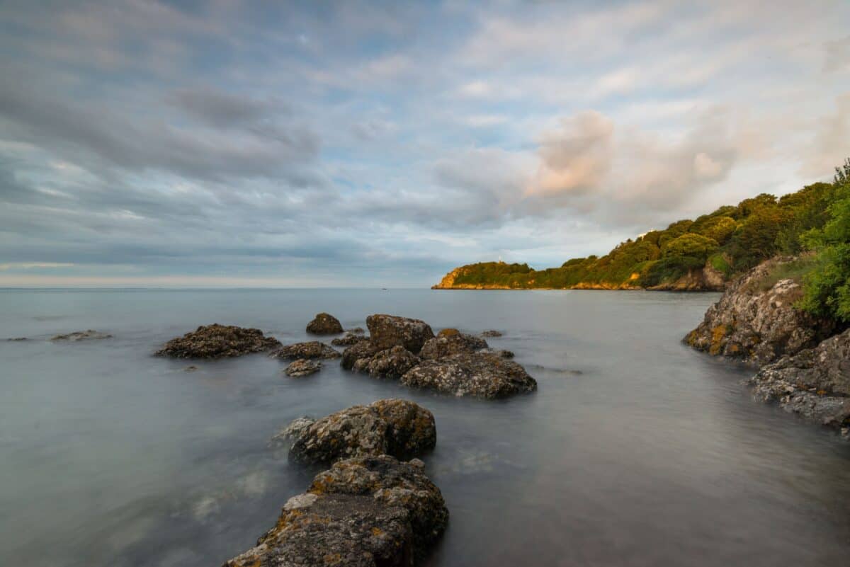 Sea, rocks and clouds at high tide at La Saie Harbour, Jersey