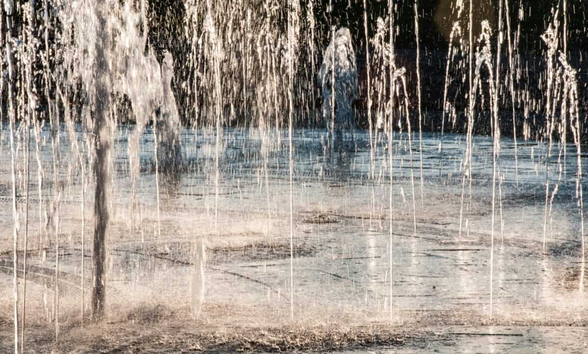 Sunlit water fountains at Les Jardins de la Mer, St. Helier