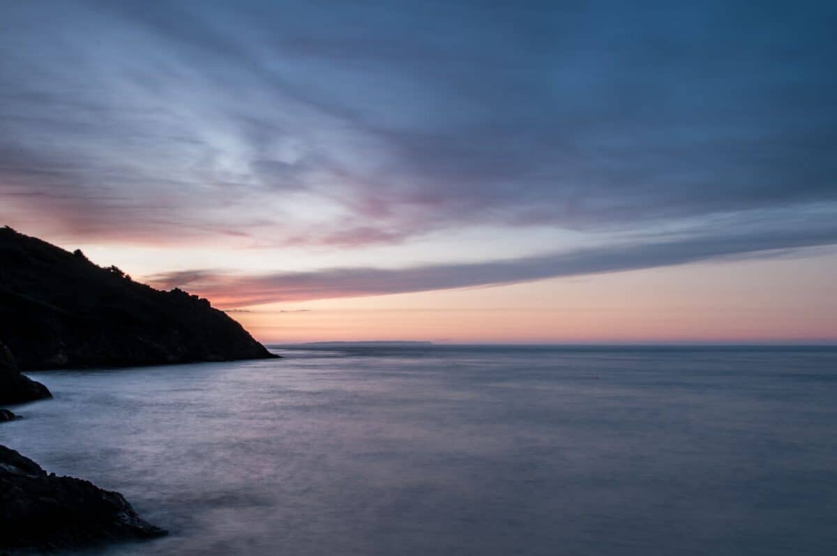 Sunset at Grève De Lecq looking up the coast to Sark, St. Ouen