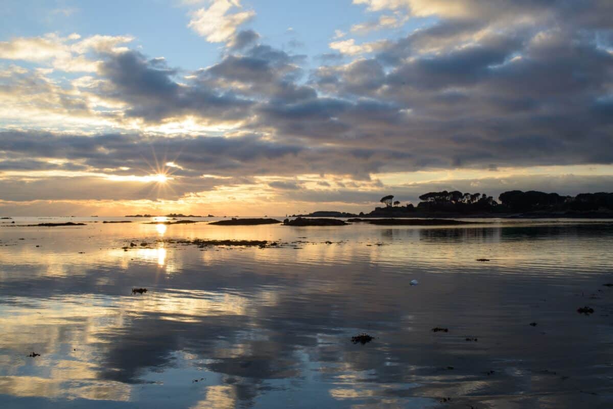 Sunset reflected in the sand and sea at Le Hocq, St. Clement