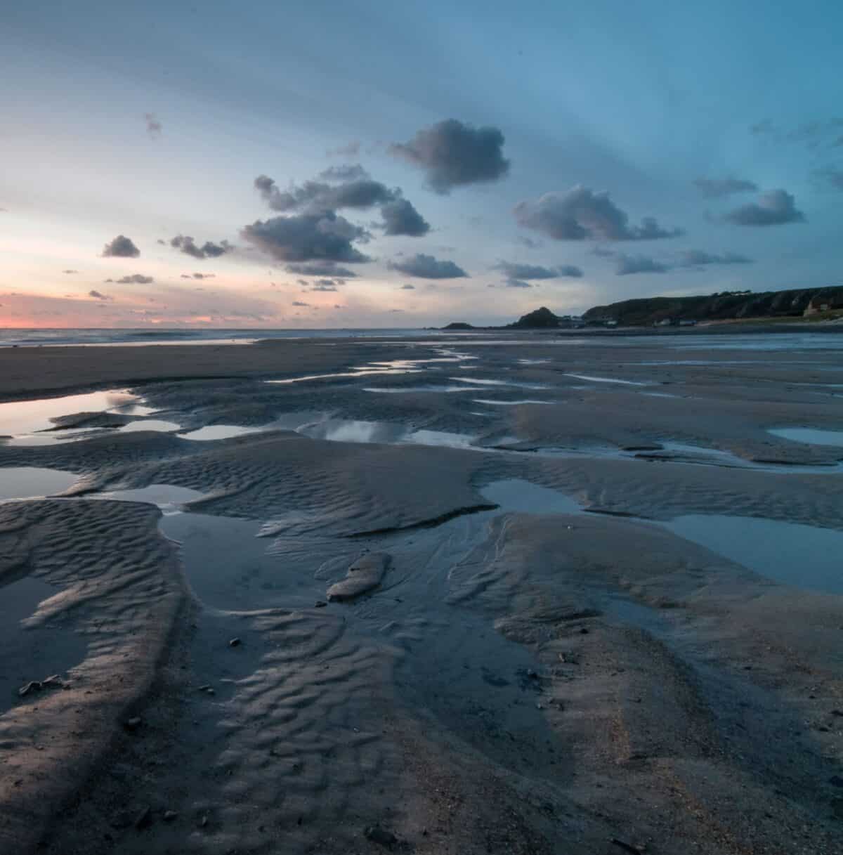 Sunset in the sand puddles at St. Ouen's Bay, St. Ouen, Jersey
