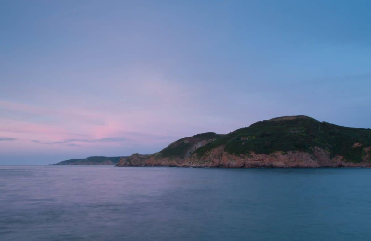 Sunset at Grève De Lecq looking along the coast to Sorel Point