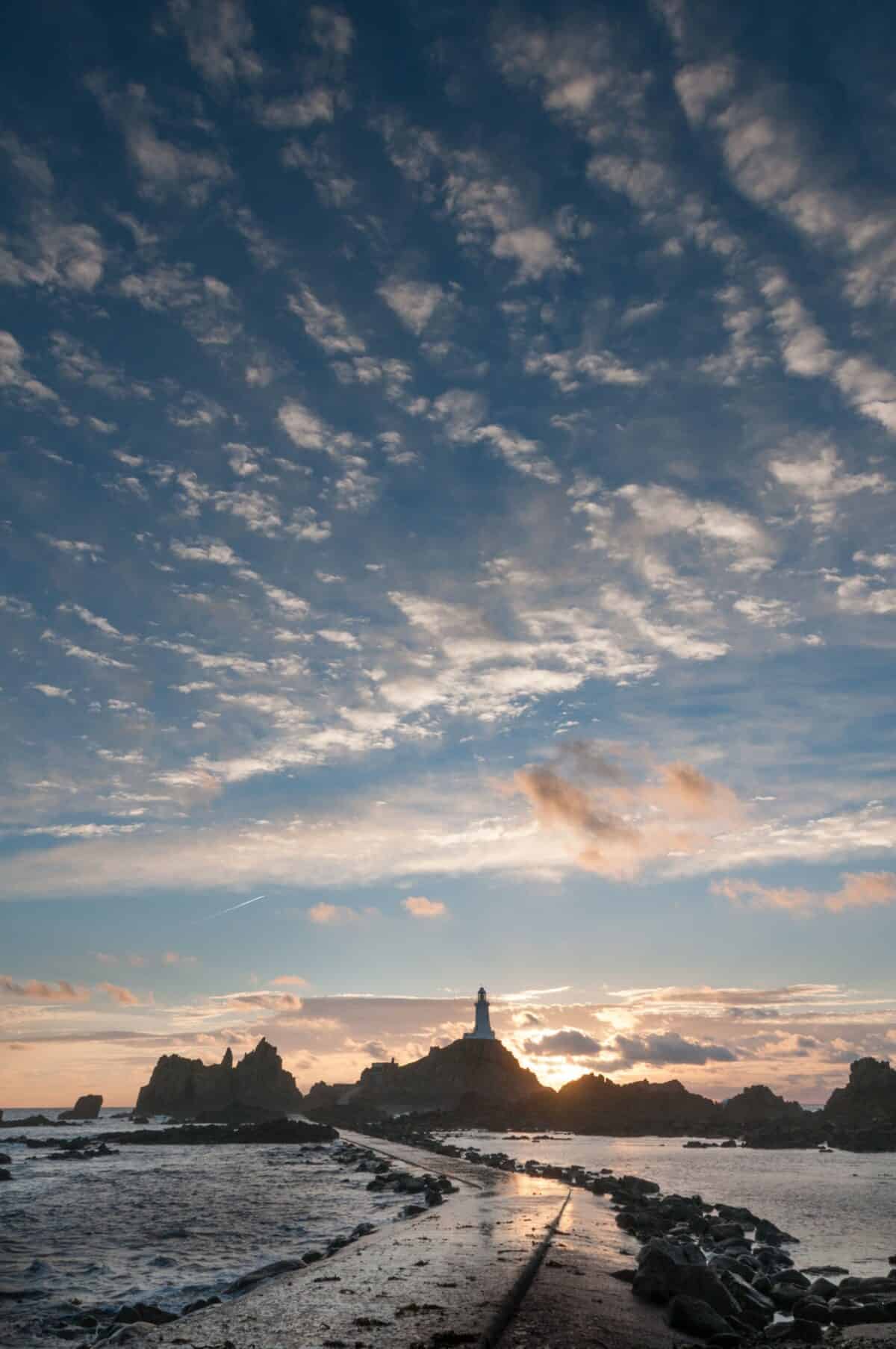 Sunset on Corbière Lighthouse causeway, St. Brelade, Jersey