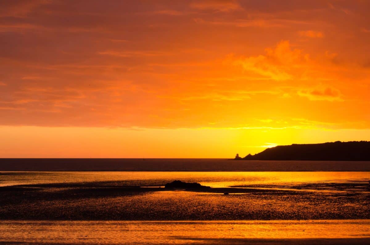 Sunset sand accross St. Aubin's Bay towards Noirmont Headland