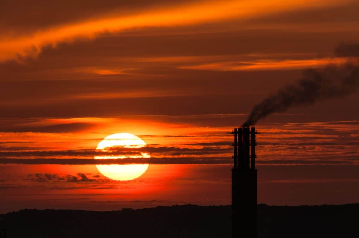 Large sunset next to silhouette of La Collette Power Station