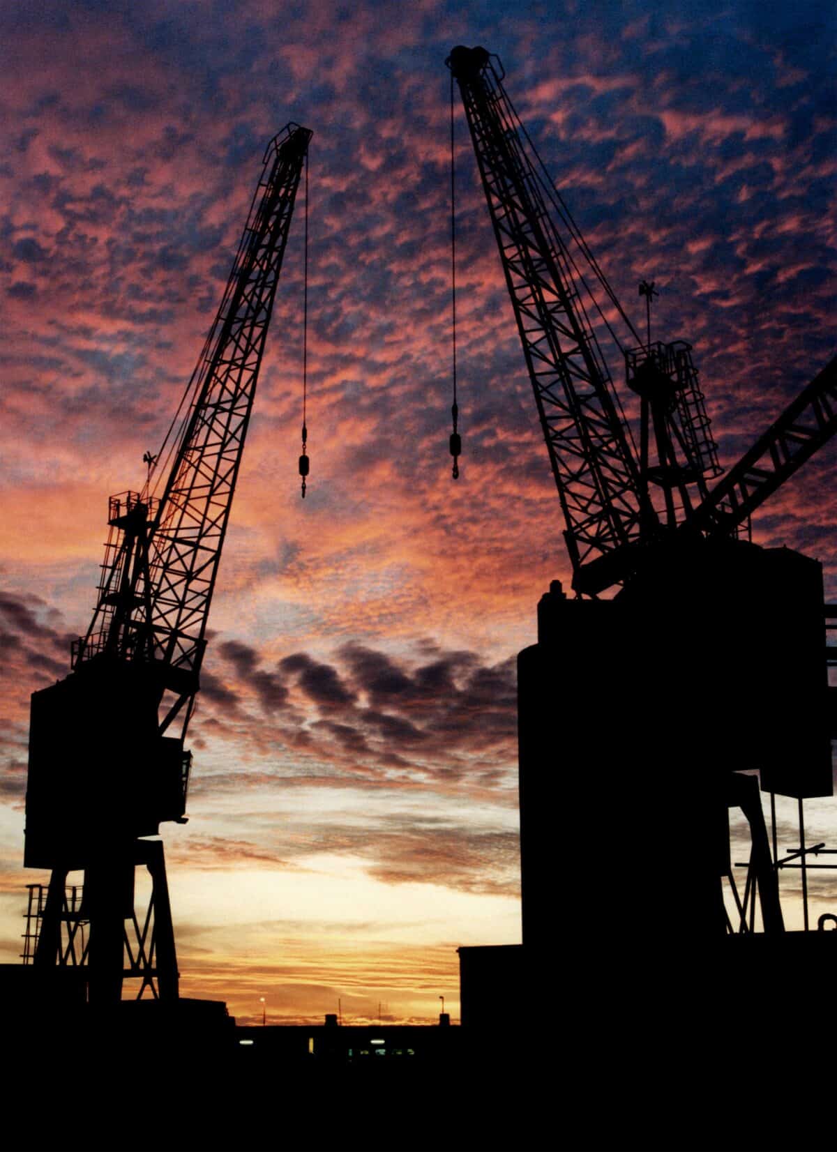 Two cranes on New North Quay at sunset, St. Helier Harbour