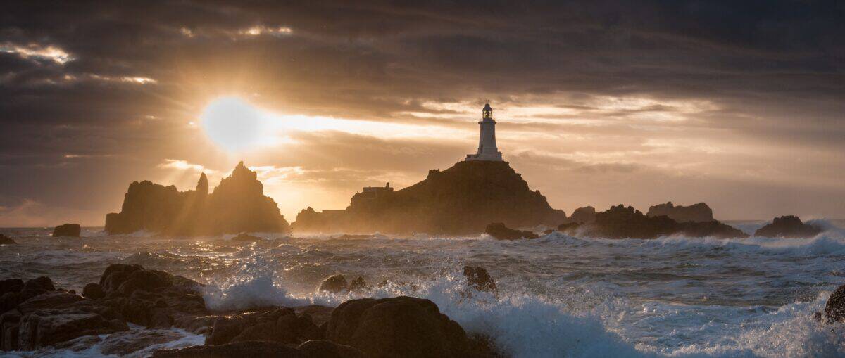 Waves and surf and sunset at Corbière Lighthouse, St. Brelade