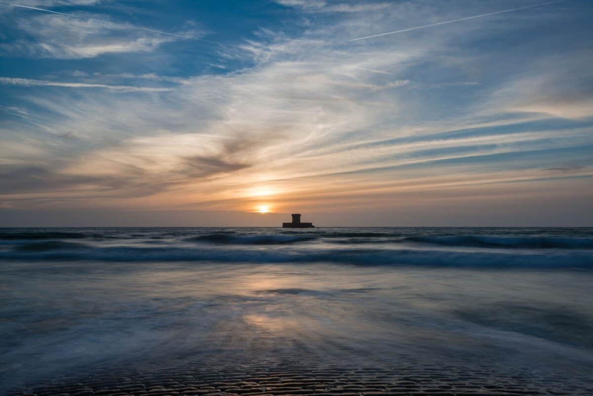 Long exposure seascape showing La Rocco Tower at sunset
